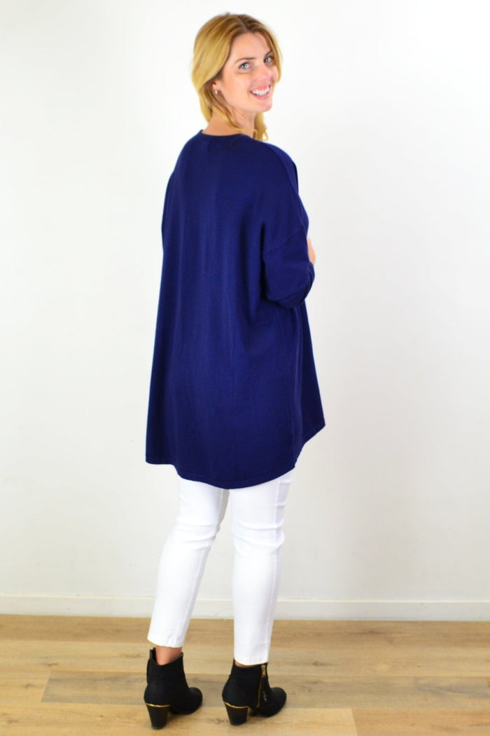 Navy blue wool blend fine knit tunic top by Cali&Co, featuring long sleeves and a relaxed fit, displayed on a hanger.