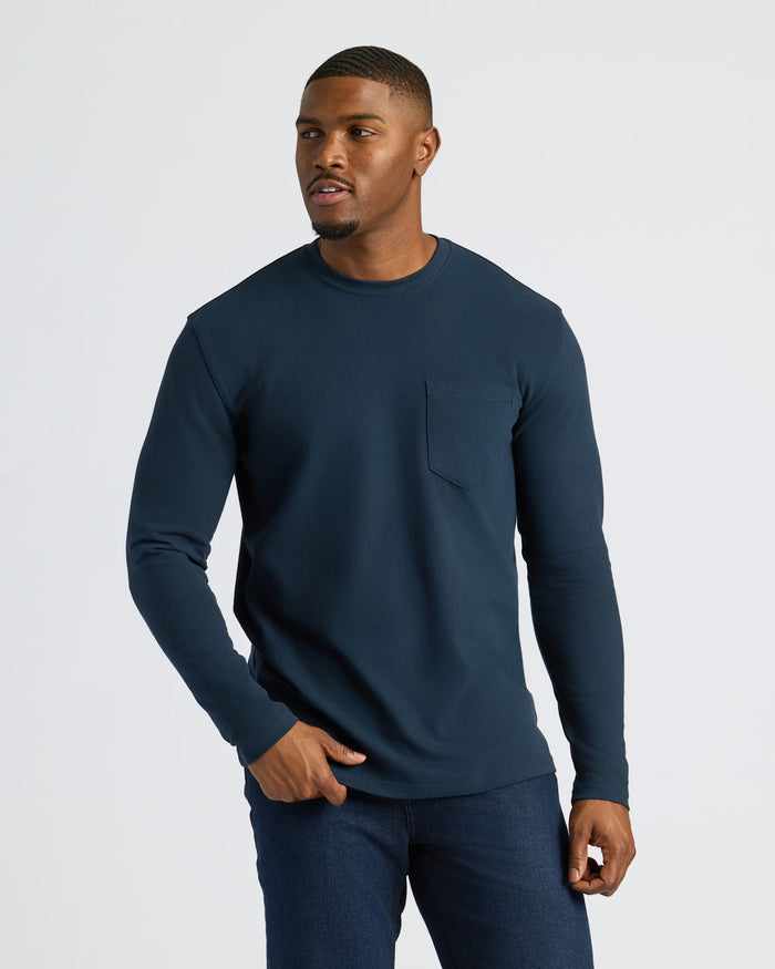 Man in Navy Tall Heavyweight Long Sleeve Pocket Crew with jeans.