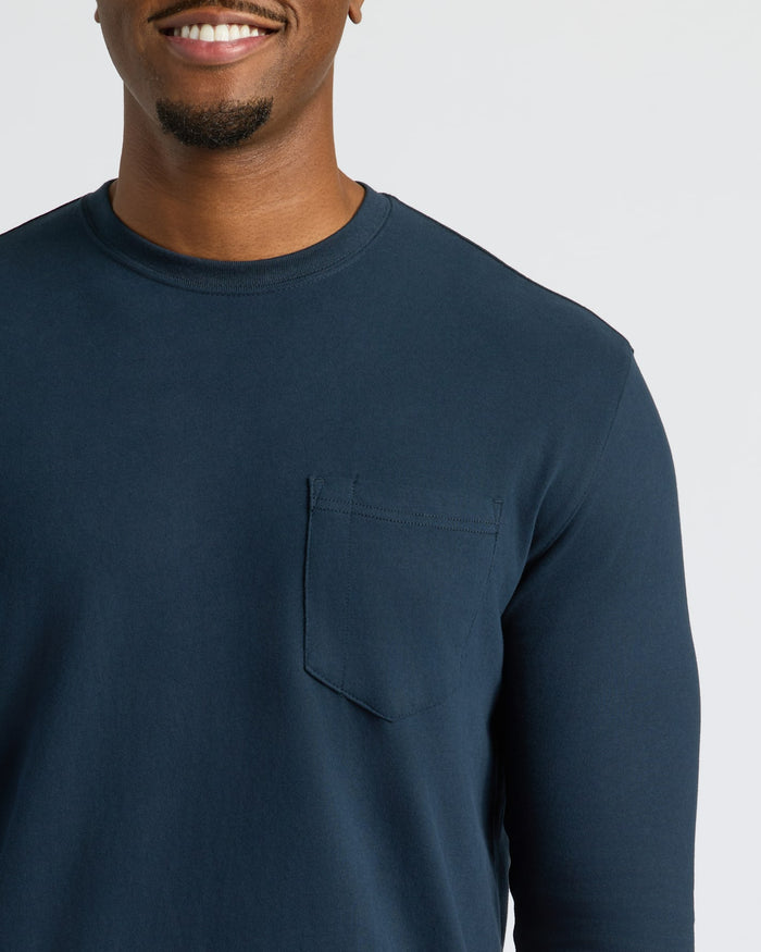 Man wearing Navy Tall Heavyweight Long Sleeve Pocket Crew with chest pocket.