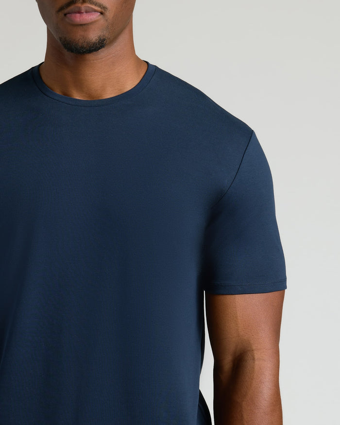 Close-up of a man wearing a Navy Tall Pima Cotton Blend Crew shirt, showcasing the smooth fabric and classic fit of this men's basics essential.