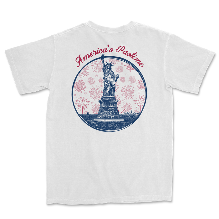 White t-shirt featuring a graphic of the Statue of Liberty with "America's Pastime" text and fireworks design.