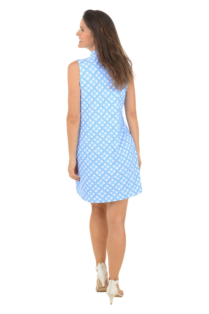Woman wearing a blue patterned dress on a white background