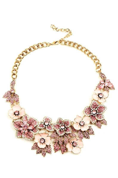 Pink Amata statement necklace with a chunky pink floral design, sparkling pink stones, pink enamel details, and gold-tone accents.
