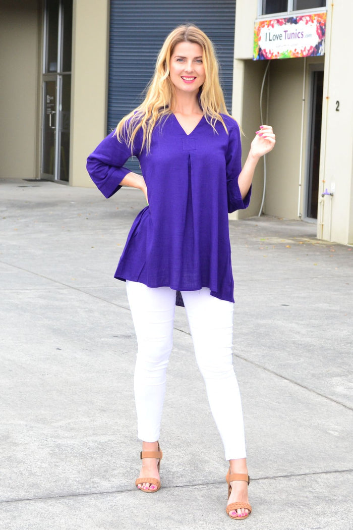 Purple linen cotton tunic top with pocket from Ruby Rain, shown on a hanger with a relaxed fit and soft fabric texture.