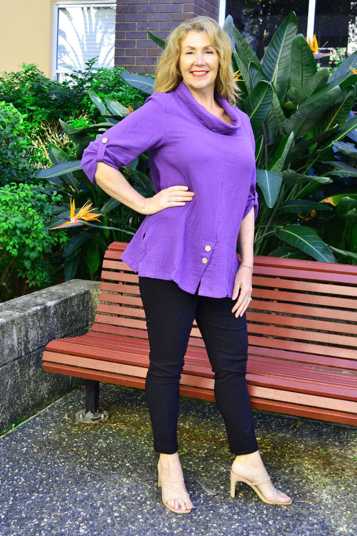Purple rolled neck coconut button tunic top by Ruby Rain, close-up of fabric with coconut button details and rolled neckline.