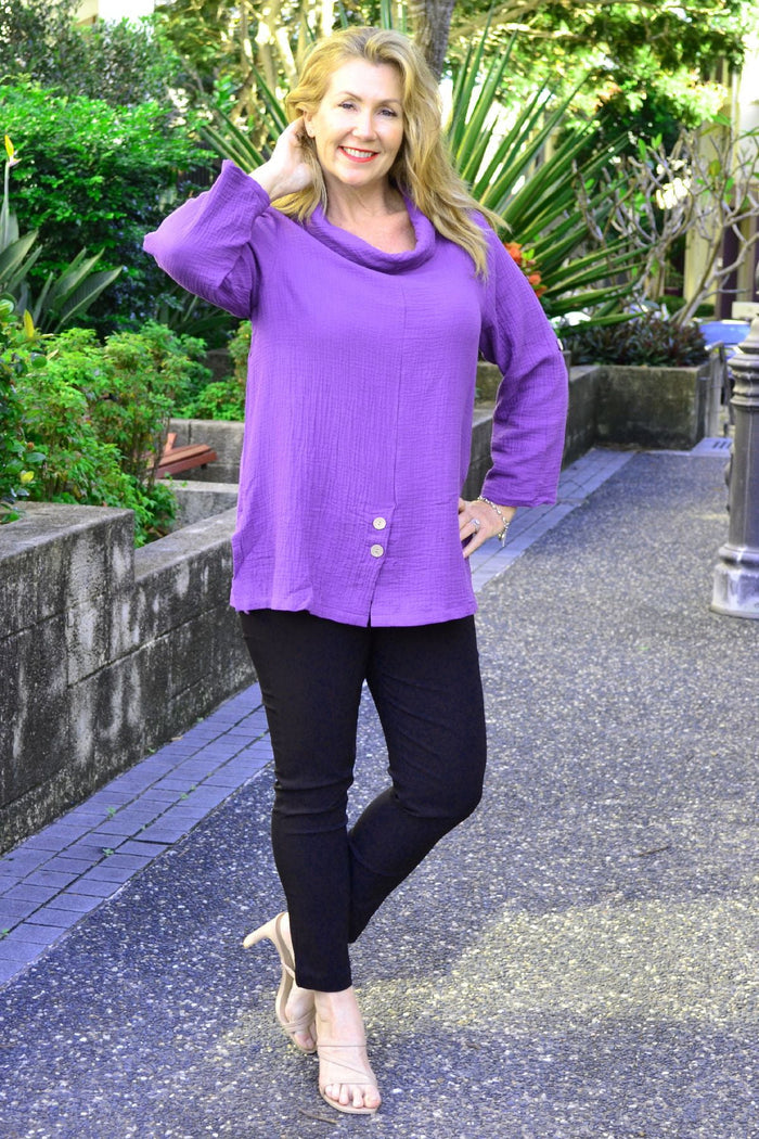 Purple rolled neck coconut button tunic top by Ruby Rain, featuring a cozy neckline and casual fit, displayed on a hanger.