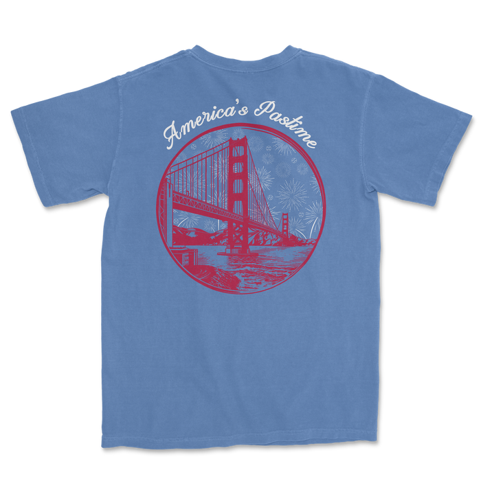 Blue t-shirt featuring a graphic of the Golden Gate Bridge with the text "America's Pastime" and fireworks in the background.