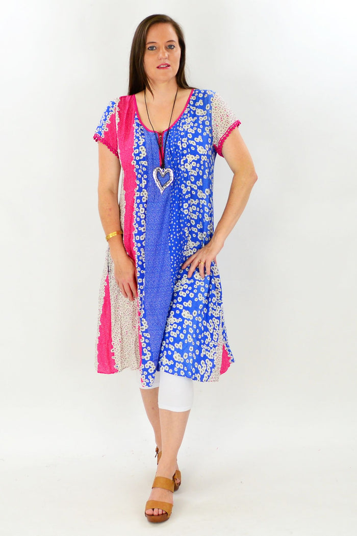 Cafe Latte Shellies Tunic Dress hanging on a hanger, showcasing its relaxed fit and soft fabric in a neutral color.