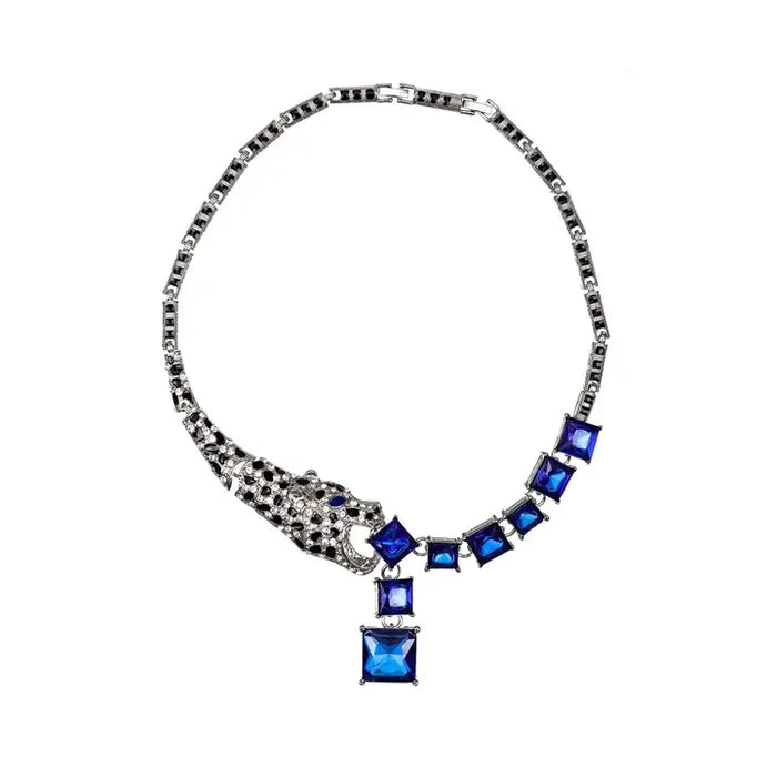 Silver tone statement necklace with blue crystal stones, a lynx animal motif, and a blue crystal drop accent.