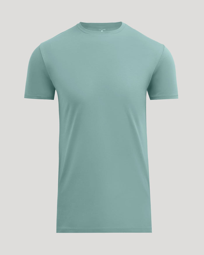 A short-sleeve crewneck t-shirt in a muted sage green color, displayed on a solid light gray background.
