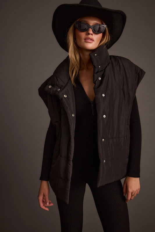 Black vest with refined detailing and a flattering silhouette.