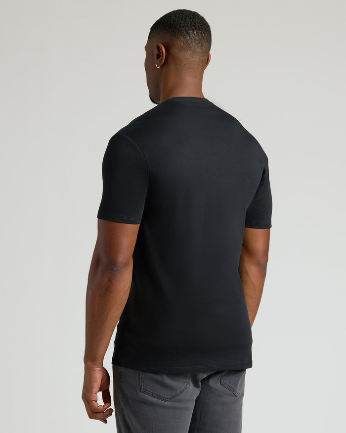 Rear view of a man wearing a black Tall Pima Cotton Blend Crew 7-Pack t-shirt, showcasing a clean, fitted style in essential men's basics.