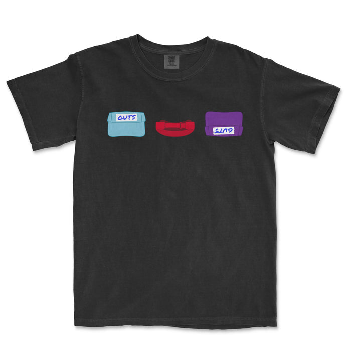 Black T-shirt featuring colorful, cartoon-style illustrations of three hats labeled "GUTS," "CUPS," and an unlabelled red hat, representing the TEAM GUTS design.