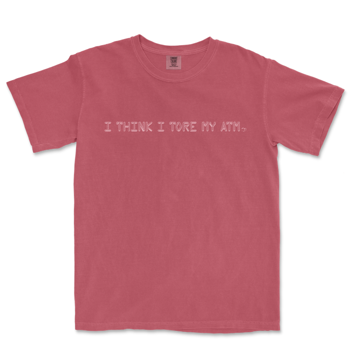 Pink T-shirt with the text "I THINK I TORE MY ATM." printed across the front in white, casual font.
