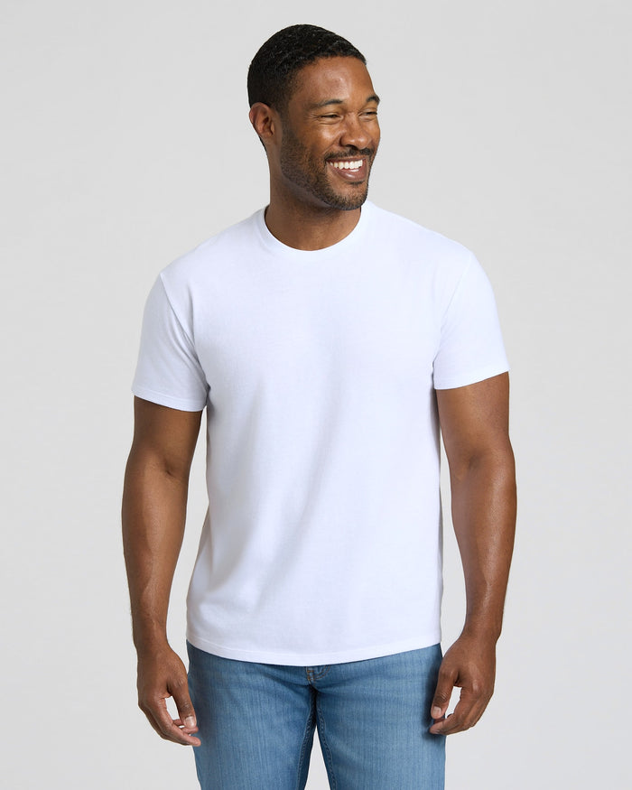 Man wearing a plain white t-shirt and blue jeans against a light background