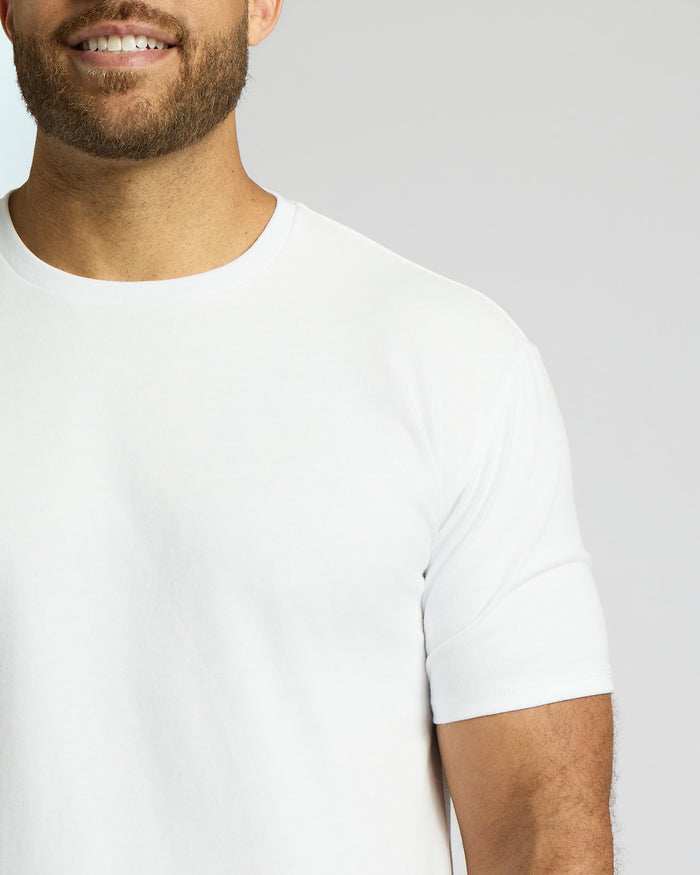 Man wearing a white Tall Heavyweight Curved Hem Crew 3-Pack shirt, showcasing the soft fabric and classic fit of this men's basics essential.