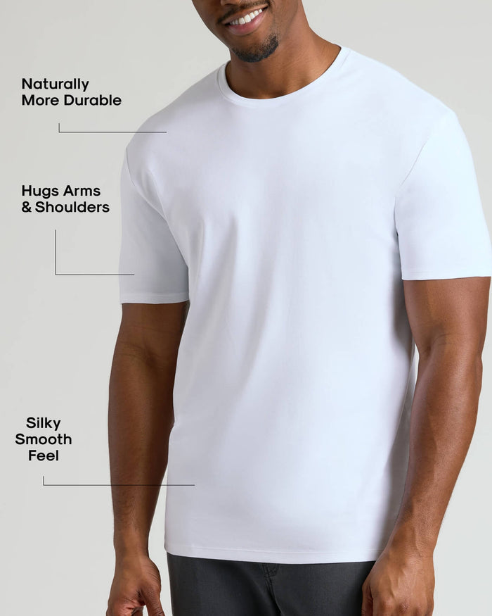 Man wearing a white Tall Pima Cotton Blend Crew 4-Pack t-shirt demonstrating a comfortable fit that hugs arms and shoulders with a smooth, durable fabric texture.