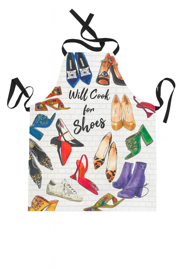 Full-length apron featuring a colorful illustrated shoe collage with the text “Will Cook For Shoes” and neck and waist tie straps.