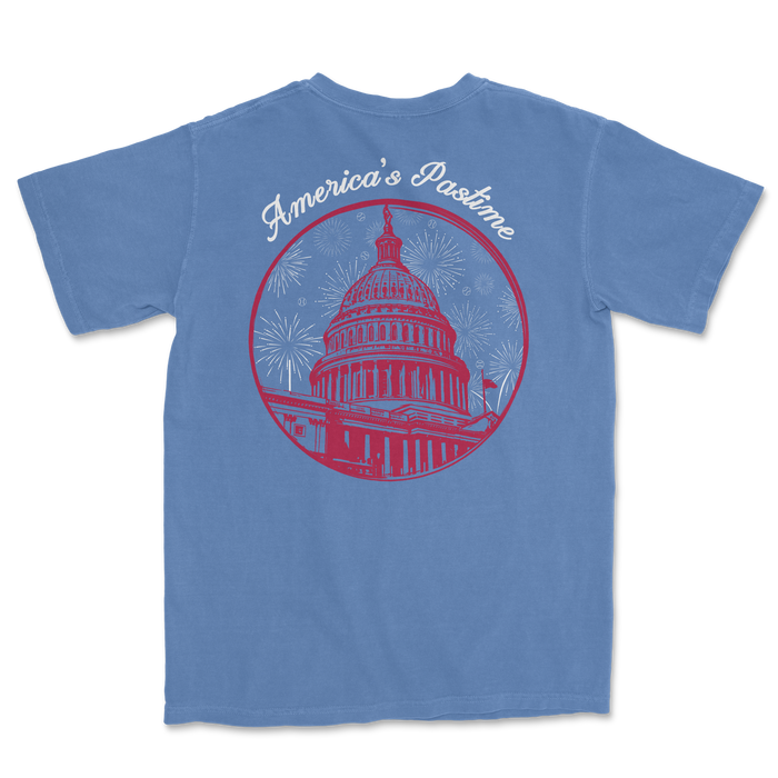 Blue t-shirt featuring a graphic of the U.S. Capitol with "America's Pastime" text and fireworks design.
